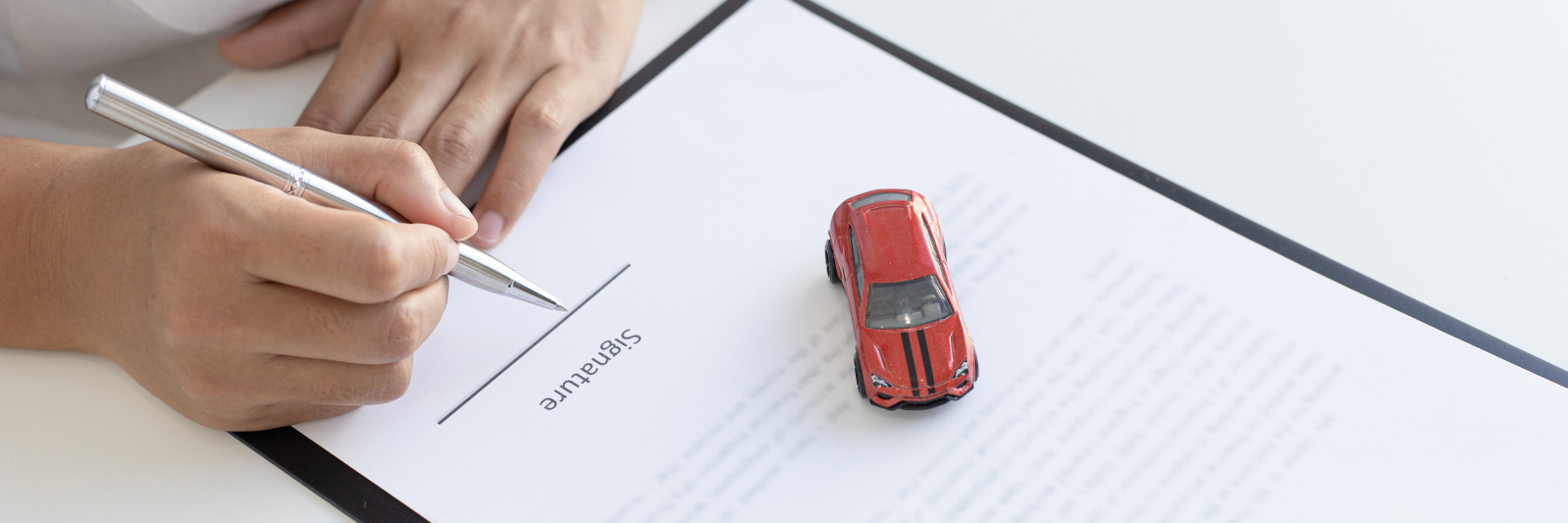 little red toy car on top of white paper